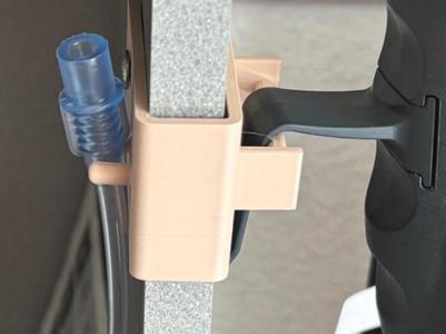 Holder for a hose and a remote control