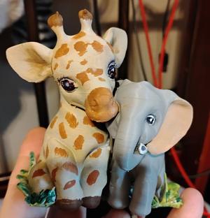 Baby giraffe and elephant