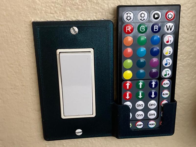 Light switch cover remote holder