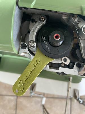 Supermatic sewing machine cam/stitch disc lifter