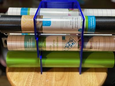 Wall mounted material roll holder