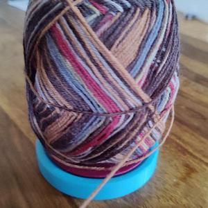Yarn ball holder with ball bearing knitting gadget