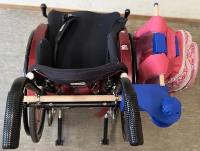 Assistive schoolbag holder for wheelchair users