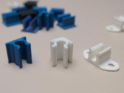 Small cable holder for corner and flat surface
