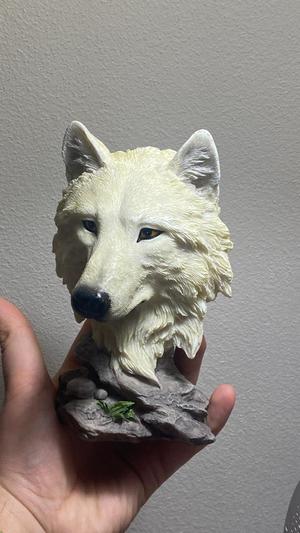 Wolf head statue on pedestal