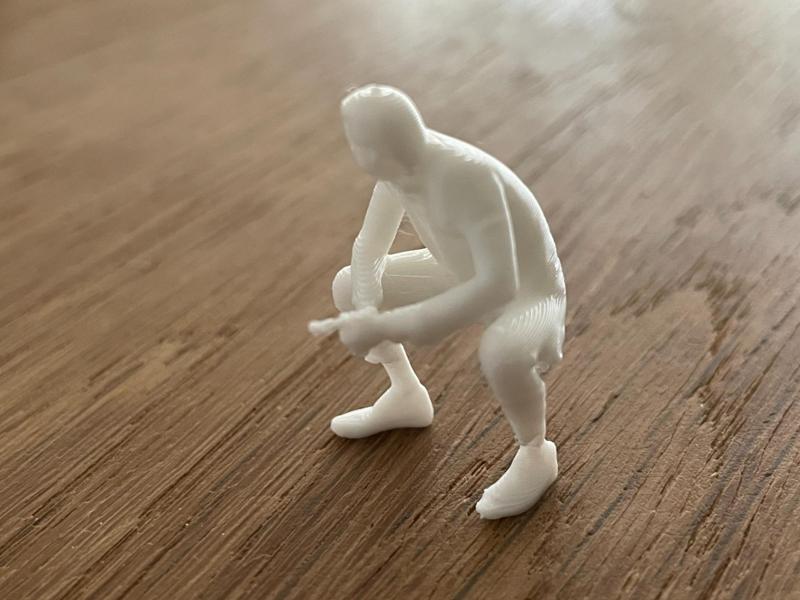 Small seated man with cigar