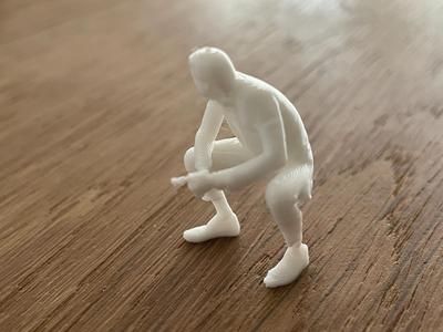 Small seated man with cigar