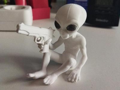 Sitting  White Alien with Gun