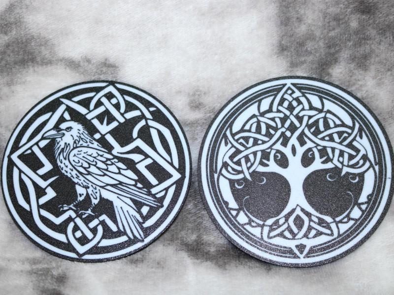 Coasters with pattern of raven and tree