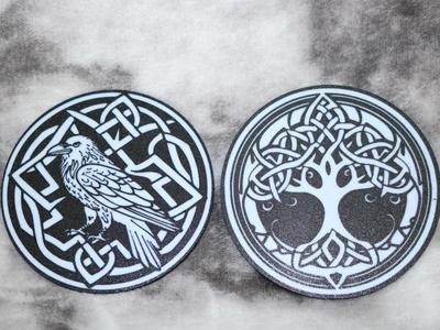 Coasters with pattern of raven and tree