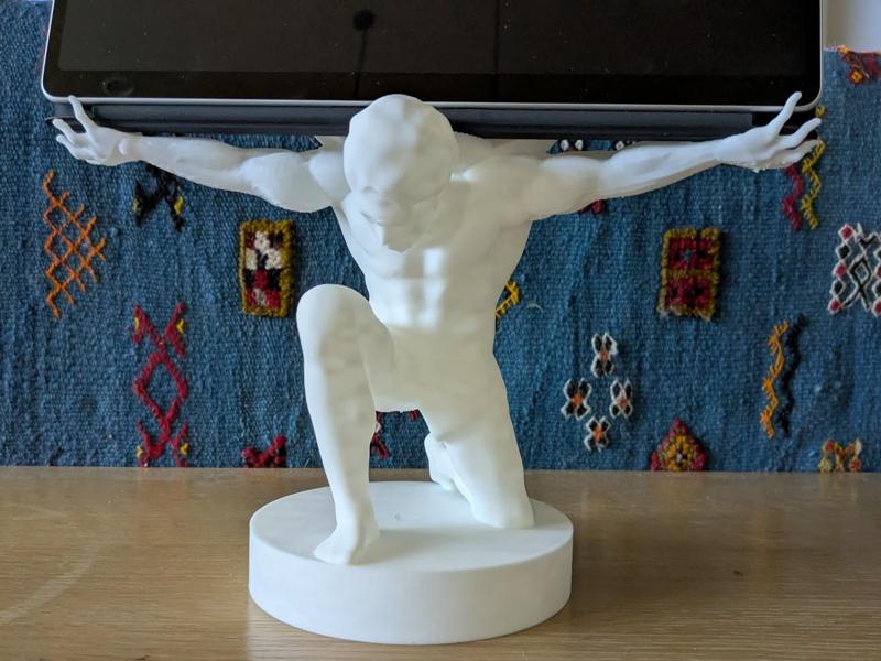 Outstretched arms holding modern world Surface Pro