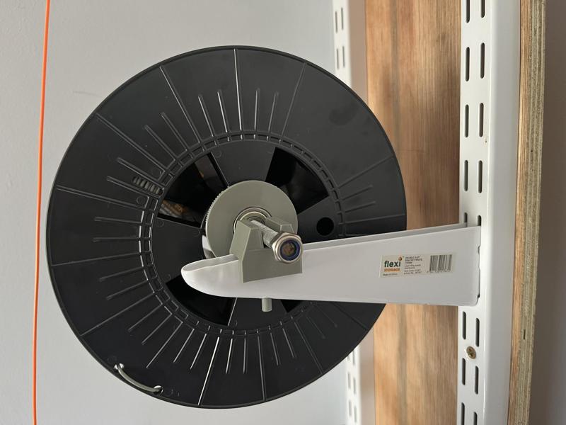 Another spool holder, fits on shelving rails (OpenSCAD)