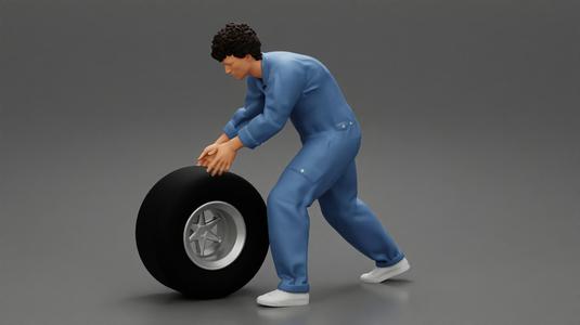 Mechanic worker walking and rolling tyre