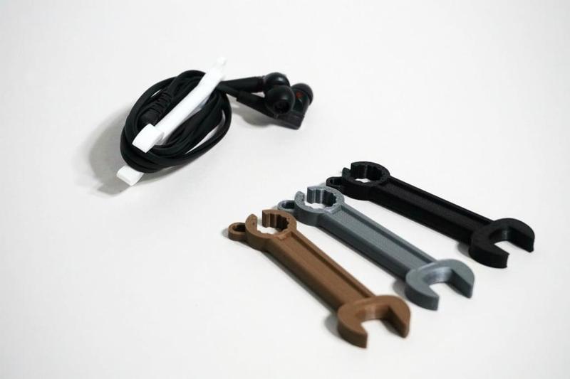Wrench shaped earphone holder