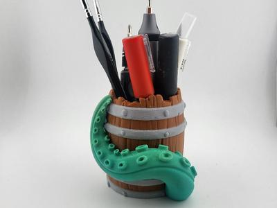 Pen holder in the shape of a barrel with tentacle