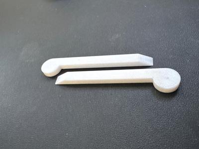 Scraper for removing adhesive residue