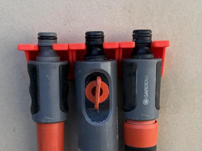 Wall mount for nozzle spray garden irrigation