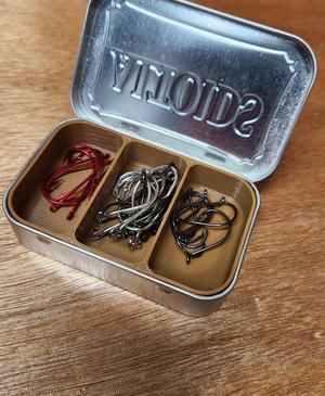 Fish hooks in an Altoids tin