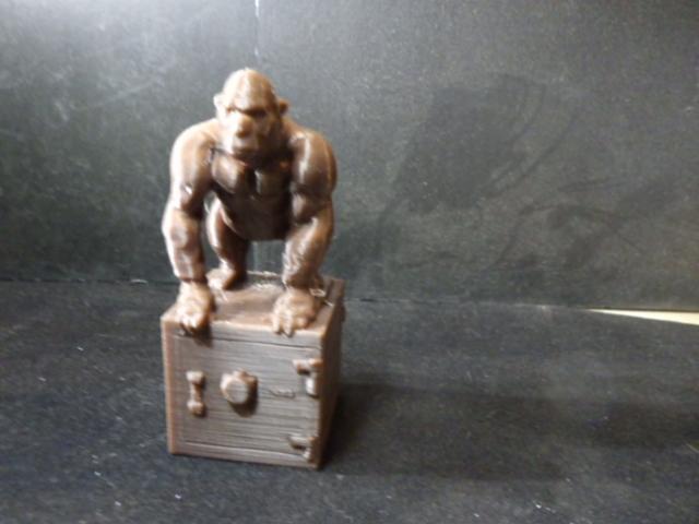 Gorilla standing on a safe.