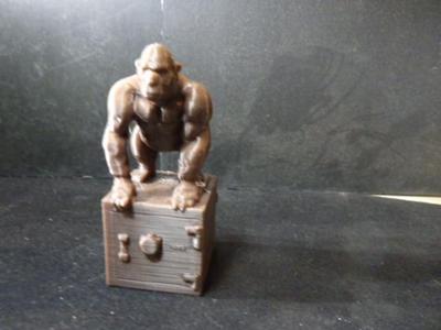 Gorilla standing on a safe.