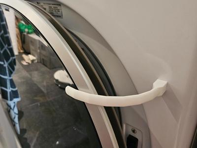 Washing machine door holder