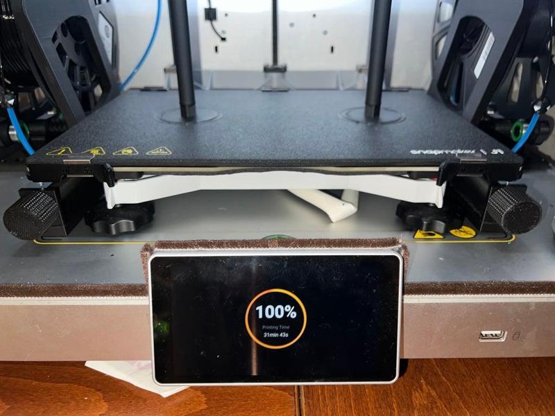 Front load spool holder with right-angle gear drive for front panel adjustment